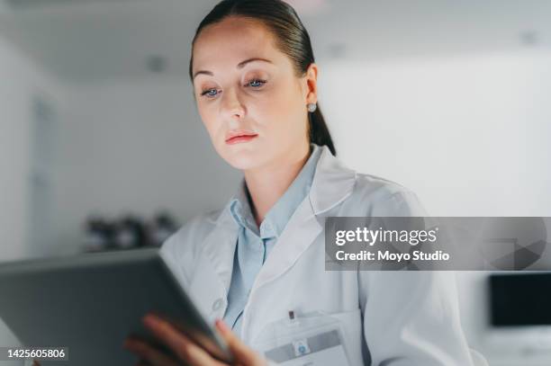 doctor, serious and reading tablet with news about safety regulations and procedure online. public healthcare digital media announcement on social media app with anxious medical worker. - media days stockfoto's en -beelden