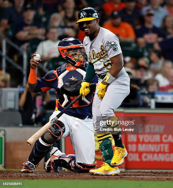 Tony Kemp of the Oakland Athletics reacts to getting fooled on a pitch as Martin Maldonado of the Houston Astros catches at Minute Maid Park on...