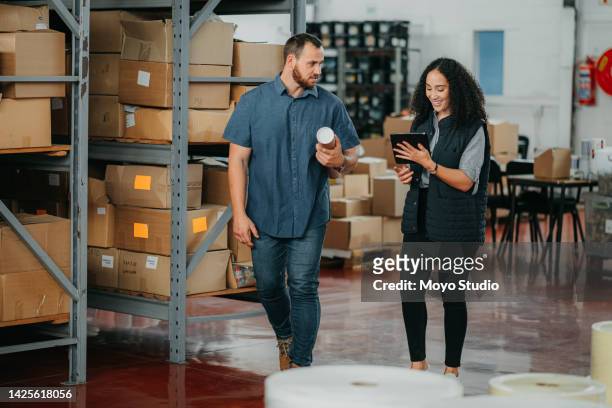 factory, warehouse or logistics manager talking to a coworker about online orders on a tablet. colleagues in the cargo or delivery industry having a discussion about import and export goods - personal organizer bildbanksfoton och bilder