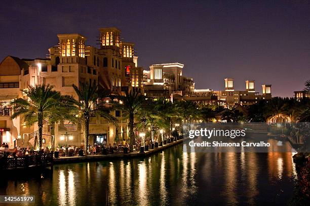 madinat al jumeirah arab city scene at night - madinat jumeirah hotel stock pictures, royalty-free photos & images