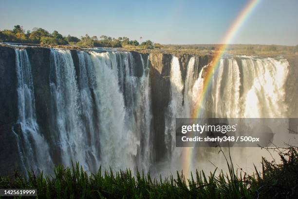 scenic view of waterfall against sky,victoria falls,zimbabwe - victoria falls stock pictures, royalty-free photos & images