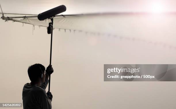 sound boom operator recording sound by microphone fisher for movie set in a studio,bangkok,thailand - mikrofonhållare bildbanksfoton och bilder