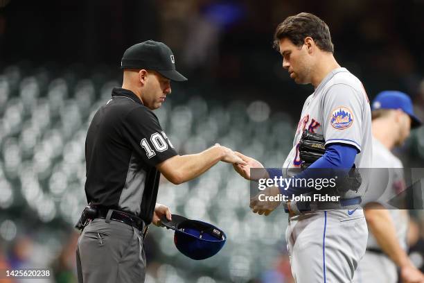 Adam Ottavino of the New York Mets is checked by the umpire before pitching in the in the ninth inning against the Milwaukee Brewers at American...