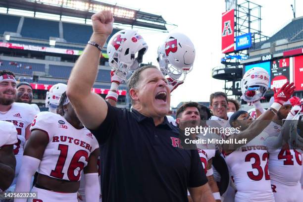 Head coach Greg Schiano of the Rutgers Scarlet Knights celebrates with along with his team after the game against the Temple Owls at Lincoln...