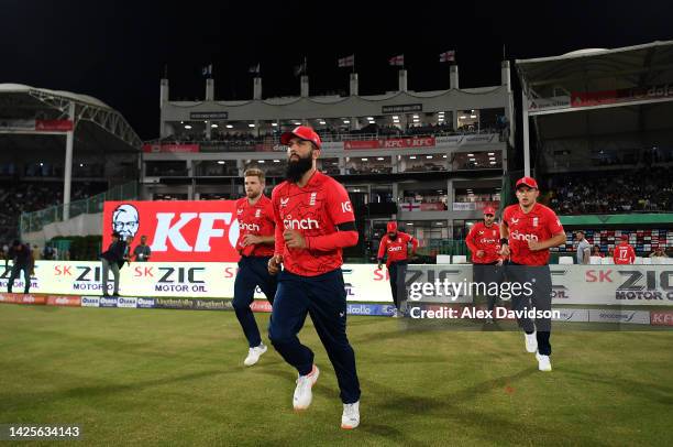 Moeen Ali of England leads his side out during the 1st IT20 match between Pakistan and England at Karachi National Stadium on September 20, 2022 in...