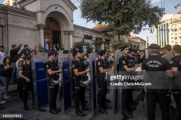 Police block Istanbul's famous Istiklal street as they disperse people trying to hold a protest over the death of Iranian Mahsa Amini on September...