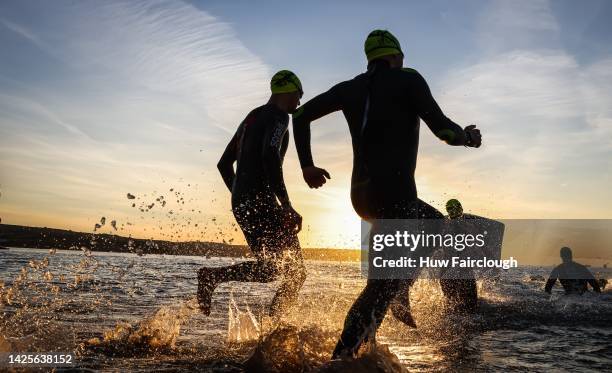 Athletes enter the sea to start racing the swim section of the race during the IRONMAN 70.3 Weymouth on September 18, 2022 in London, England.