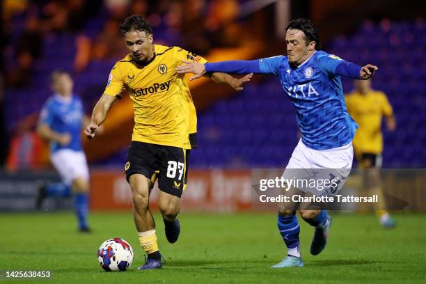 Tyler Roberts of Wolverhampton Wanderers is challenged by James Brown of Stockport County during the Papa John's Trophy match between Stockport...