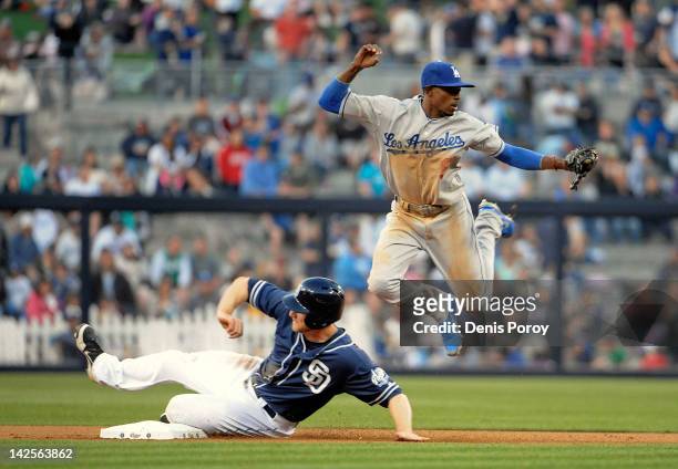 Dee Gordon of the Los Angeles Dodgers jumps over Chase Headley of the San Diego Padres after getting the force out during the fifth inning Petco Park...