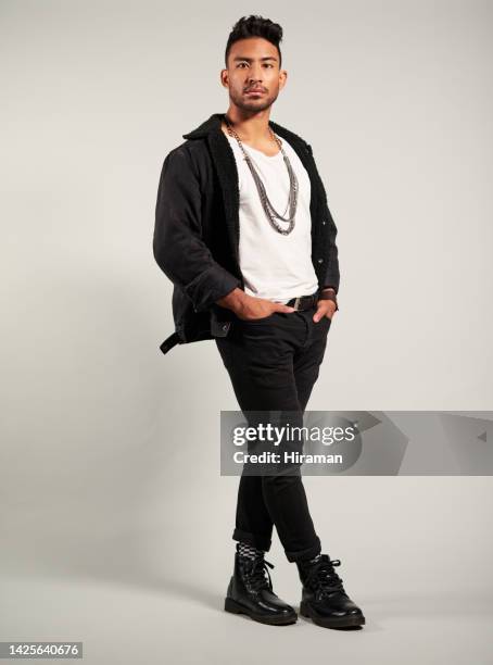 fashion, model and trendy man posing with a cool attitude against a studio background, confident and handsome. portrait of asian male showing his edgy style, looking proud, stylish and fashionable - male model casual imagens e fotografias de stock