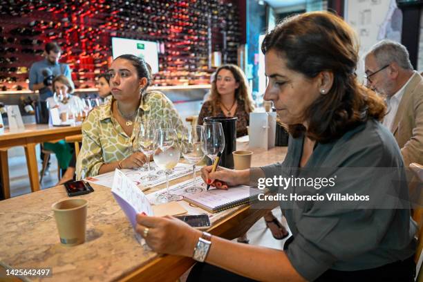 Participant takes notes after trying different wines during a presentation to the press of the new European campaign of Wines of Spain and Portugal...