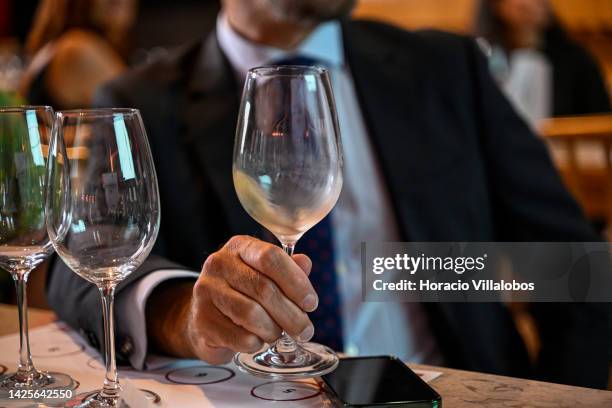 Participant swirls wine in a glass to encourage the aroma to emerge during a presentation to the press of the new European campaign of Wines of Spain...