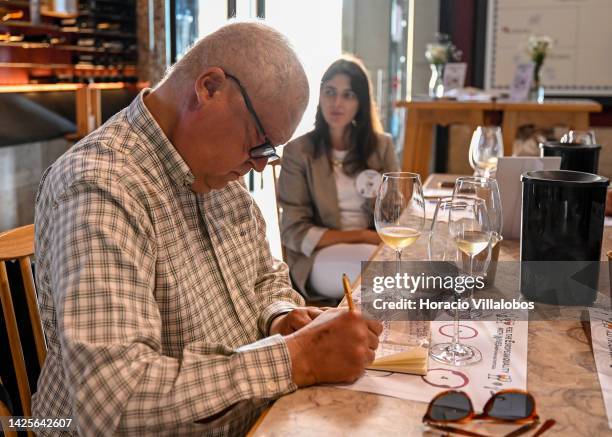 Participant takes notes after trying different wines during a presentation to the press of the new European campaign of Wines of Spain and Portugal...