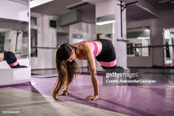 burpees in gym by athletic female - rubber band workout stock pictures, royalty-free photos & images