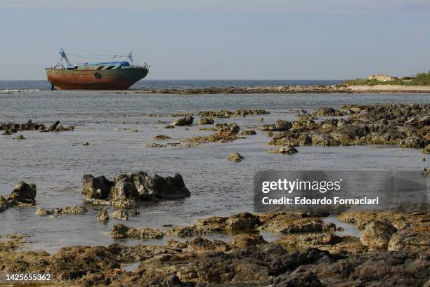 Portopalo di Capo Passero, a Libic fishing boat abandoned by illegal immigrants on the shore near L'Isola delle Correnti .