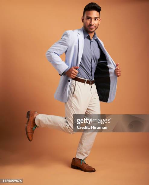 professional fashion, business man portrait in studio with orange color background for corporate or formal style. handsome, young and confident corporate man in designer suit for career or job mockup - menswear stock pictures, royalty-free photos & images
