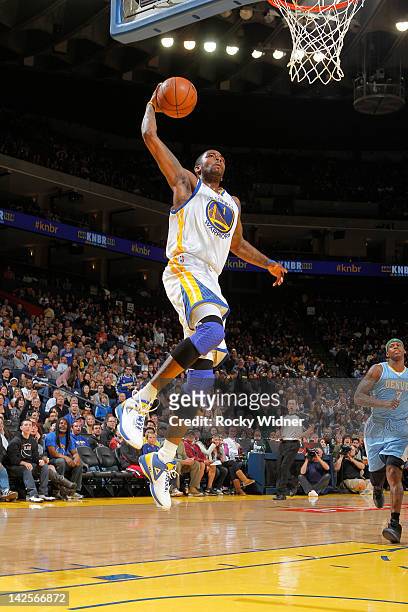 Dorell Wright of the Golden State Warriors dunks the ball against the Denver Nuggets on April 07, 2012 at Oracle Arena in Oakland, California. NOTE...