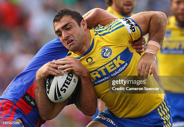 Tim Mannah of the Eels is tackled during the round six NRL match between the Newcastle Knights and the Parramatta Eels at Hunter Stadium on April 8,...