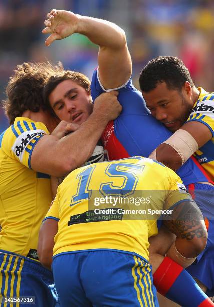 Kade Snowden of the Knights is tackled during the round six NRL match between the Newcastle Knights and the Parramatta Eels at Hunter Stadium on...
