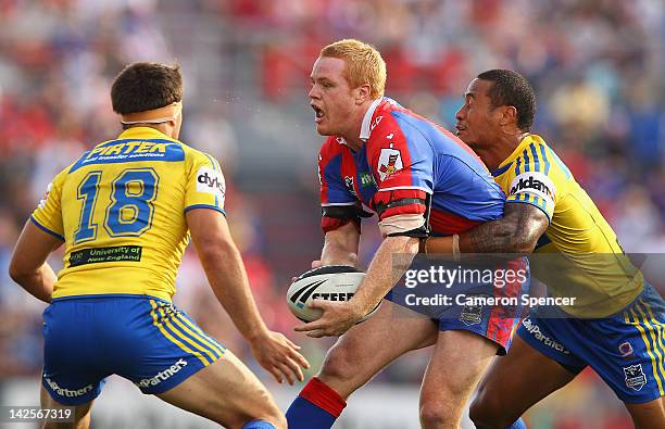 Joel Edwards of the Knights is tackled during the round six NRL match between the Newcastle Knights and the Parramatta Eels at Hunter Stadium on...