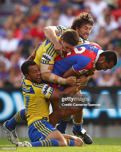 Zeb Taia of the Knights is tackled during the round six NRL match between the Newcastle Knights and the Parramatta Eels at Hunter Stadium on April 8,...