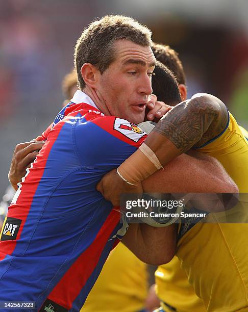 Chris Houston of the Knights is tackled during the round six NRL match between the Newcastle Knights and the Parramatta Eels at Hunter Stadium on...