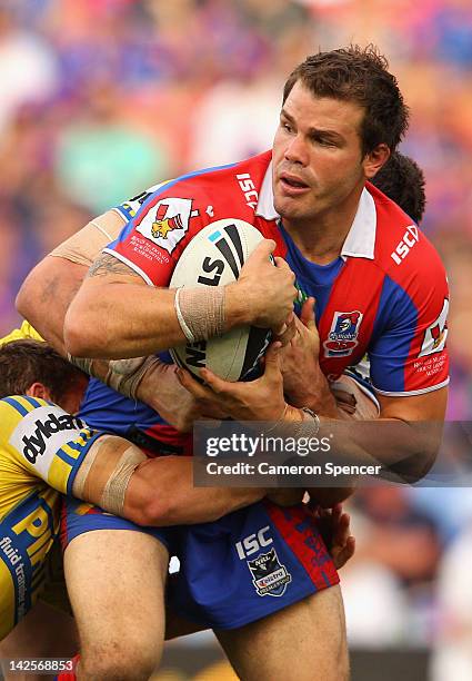 Adam Cuthbertson of the Knights is tackled during the round six NRL match between the Newcastle Knights and the Parramatta Eels at Hunter Stadium on...