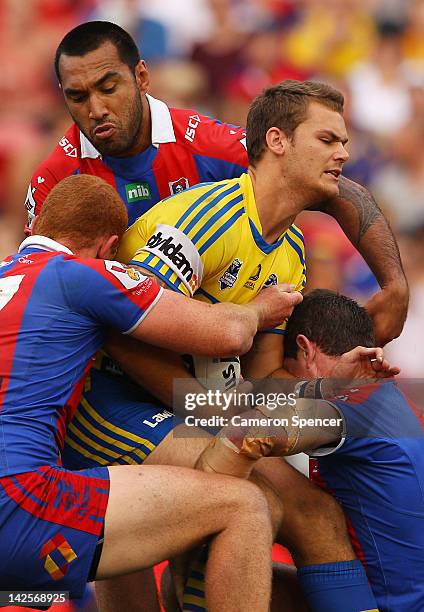 Cheyse Blair of the Eels is tackled during the round six NRL match between the Newcastle Knights and the Parramatta Eels at Hunter Stadium on April...