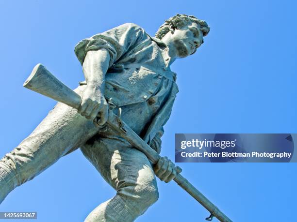 the minuteman statue stands proud over lexington battlefield green, september 2022 - lexington massachusetts stock pictures, royalty-free photos & images