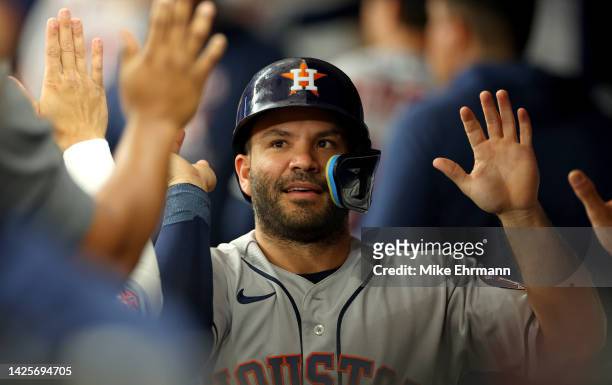 Jose Altuve of the Houston Astros is congratulated after scoring a run in the first inning during a game against the Tampa Bay Rays at Tropicana...