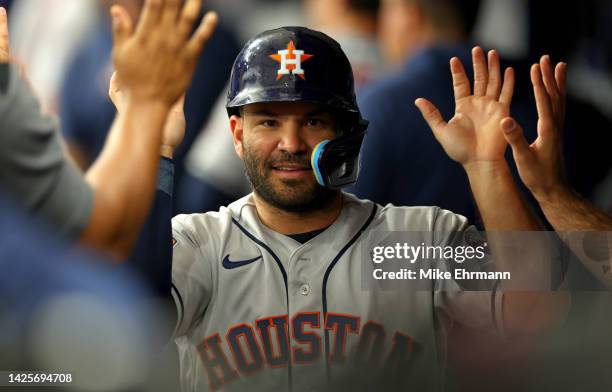 Jose Altuve of the Houston Astros is congratulated after scoring a run in the first inning during a game against the Tampa Bay Rays at Tropicana...