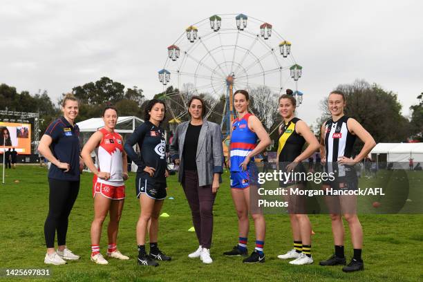 Nicole Livingstone , AFL Head of Women's Football poses alongside Maddison Gay of the Melbourne Demons, Brooke Lochland of the Sydney Swans,...