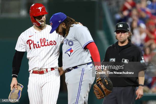 Bryce Harper of the Philadelphia Phillies and Vladimir Guerrero Jr. #27 of the Toronto Blue Jays speak during the fourth inning at Citizens Bank Park...