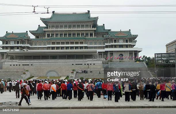 This photo taken on September 22, 2010 shows people arriving for a political gathering at a square in downtown Pyongyang. The country is moving...