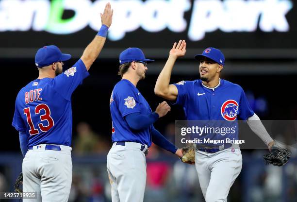 Christopher Morel of the Chicago Cubs high fives David Bote and Zach McKinstry after a 2-1 win over the Miami Marlins at loanDepot park on September...