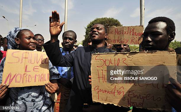 Youngs Malians from the North hold signs as they take part in a protest against the occupation of the north by Tuareg rebel fighters on April 6 in...