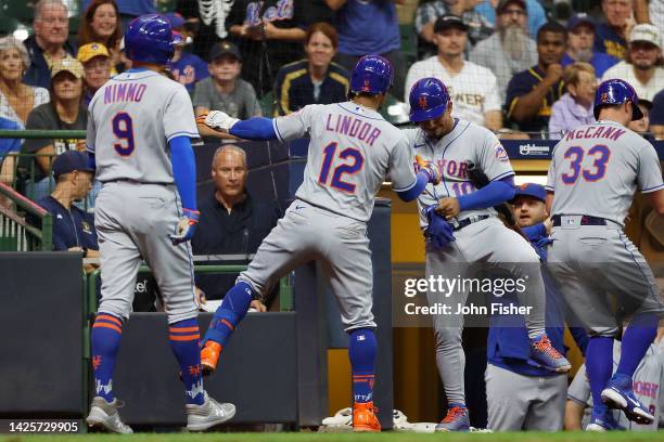 Eduardo Escobar of the New York Mets and Francisco Lindor celebrate the grand slam in the seventh inning by Lindor against the Milwaukee Brewers at...