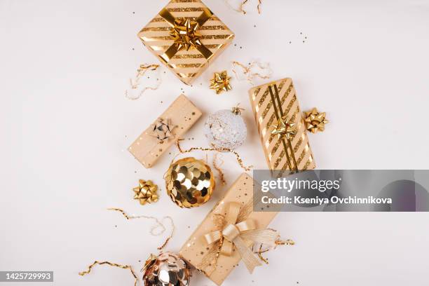 happy new year banner. christmas design gold gifts box, golden balls, glitter confetti stars on white background. decoration objects viewed from above. - gold medalist stock pictures, royalty-free photos & images