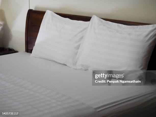 white pillow on bed - double bed stock pictures, royalty-free photos & images