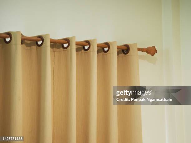pleated curtains, brown wooden rails - beige curtains stock pictures, royalty-free photos & images