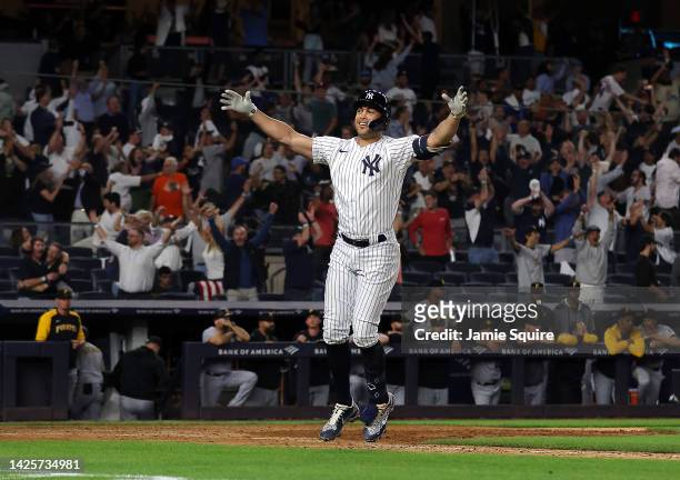 Giancarlo Stanton of the New York Yankees celebrates as he hits a walk-off grand-slam home run to end the game during the 9th inning of the game...