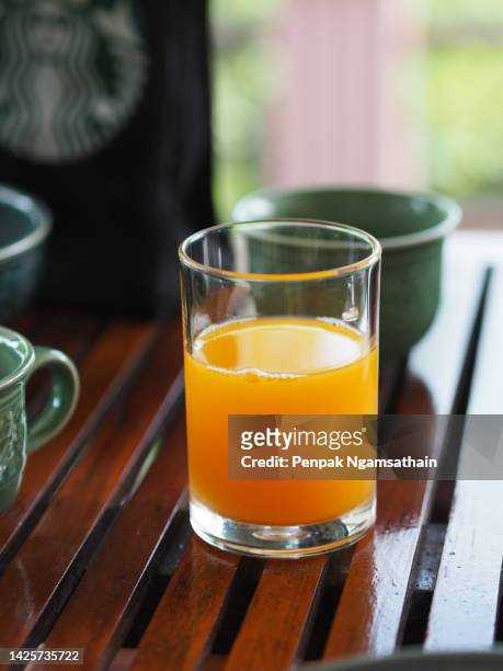 orange juice in a clear glass - orange juice stock pictures, royalty-free photos & images