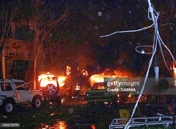 Buildings and cars burning down after bomb blast in tourist site of Kuta, Bali 13 October 2002. At least 53 people including 10 foreigners were...