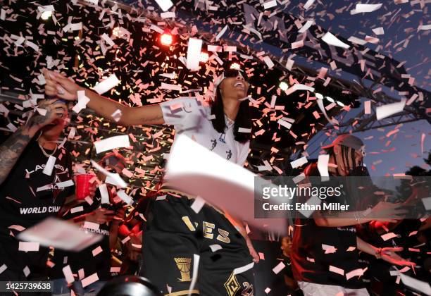 Confetti falls around A'ja Wilson of the Las Vegas Aces as she celebrates onstage during the team's WNBA championship victory parade and rally on the...