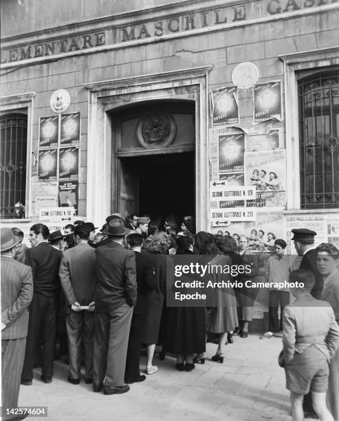 Voters queuing at a polling station in an elementary school in Italy, during the general election, 18th April 1948.