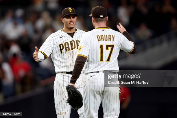 Brandon Drury and Manny Machado of the San Diego Padres celebrate defeating the St. Louis Cardinals 5-0 in a game at PETCO Park on September 20, 2022...