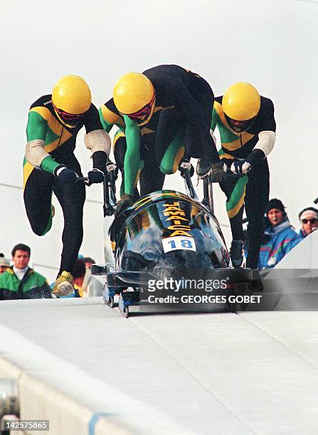 Jamaican four-man bobsleigh pilot Dudley Stokes jumps in as his three teammates push off at the start of the second run of the Olympic four-man...