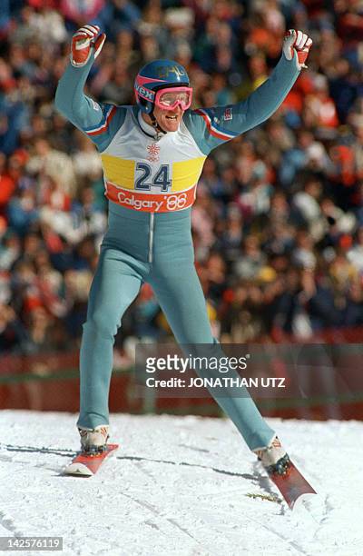 Britain's first ever Olympic ski jumper Eddie Edwards waves to the cheering crowd after completing his first safe jump during the 90m event 23...