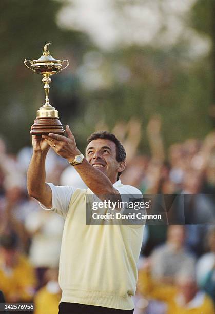 Tony Jacklin of England and European team Captain holds the trophy after winning the 28th Ryder Cup Matches on 24th September 1989 at The Belfry in...