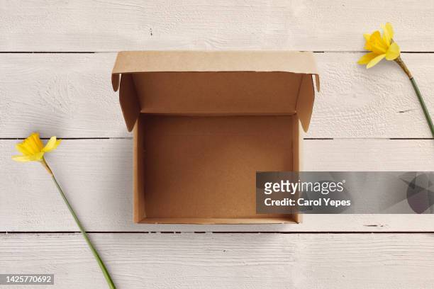 open empty brown cardboard box on wooden background. - paperboard stock pictures, royalty-free photos & images